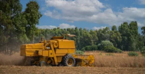 farm harvester working in a field surrounded by tr 2025 02 09 12 23 57 utc
